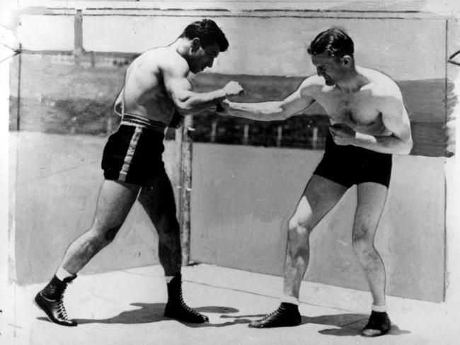 Australian welterweight champion Jack Carroll (right) with Dutch opponent Bep van Klaveran, an Olympic gold medallist