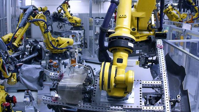 Industrial robots weld parts of the chassis of a Volkswagen Golf in a factory in Germany. Pic: AFP