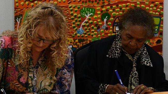 CHCA CEO Frances Paterson-Fleider (left), with CHCA Board Director Eileen Hoosan (right) signing the agreement to manage 100 public homes in Alice Springs. Picture: Supplied