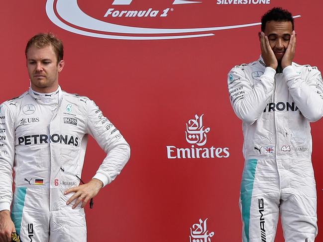 Mercedes drivers Nico Rosberg of Germany, left, and Lewis Hamilton of Britain stand on the podium of the British Formula One Grand Prix at the Silverstone racetrack, Silverstone, England, Sunday, July 10, 2016. Hamilton won the race and Rosberg was second. (AP Photo/Luca Bruno)