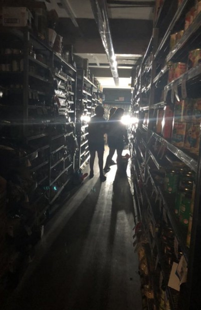 People shopping in the dark at a supermarket in Narooma. Picture: Jade Macmillan/ABC