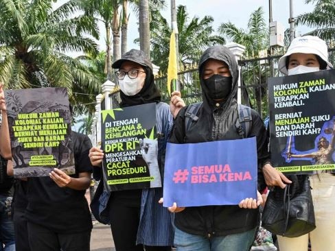 Indonesian activists hold a protest against the new criminal code outside the parliament building in Jakarta. Picture: AFP