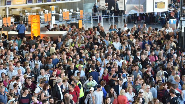 Passengers leave Terminal 1 of Frankfurt Airport as police clear the area. Picture: AFP