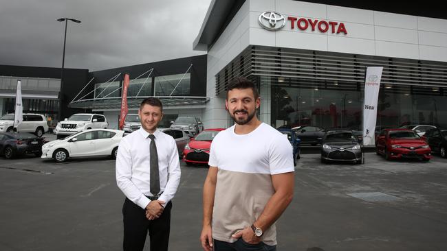 Alfie Arcuri with Clintons Toyota/Lexus dealership general manager Kane Kordovolos (left). Picture: Robert Pozo