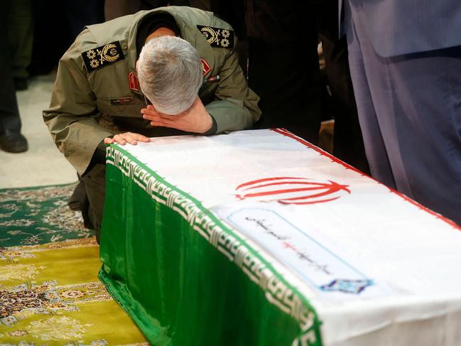 A handout picture provided by the office of Iran's Supreme Leader Ayatollah Ali Khamenei shows Iran's Revolutianary Guard commander and Chief of Staff for the Armed Forces Mohammad Bagheri praying over the casket of slain Iranian military commander Qasem Soleimani during a funeral ceremony at Tehran University in the Iranian capital on January 6, 2020. - Mourners packed the streets of Tehran for ceremonies to pay homage to Soleimani, who spearheaded Iran's Middle East operations as commander of the Revolutionary Guards' Quds Force and was killed in a US drone strike on January 3 near Baghdad airport. (Photo by - / IRANIAN SUPREME LEADER'S WEBSITE / AFP) / === RESTRICTED TO EDITORIAL USE - MANDATORY CREDIT "AFP PHOTO / HO / LEADER.IR" - NO MARKETING NO ADVERTISING CAMPAIGNS - DISTRIBUTED AS A SERVICE TO CLIENTS ===