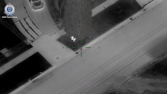 Polair footage shows suspects hiding behind a tree