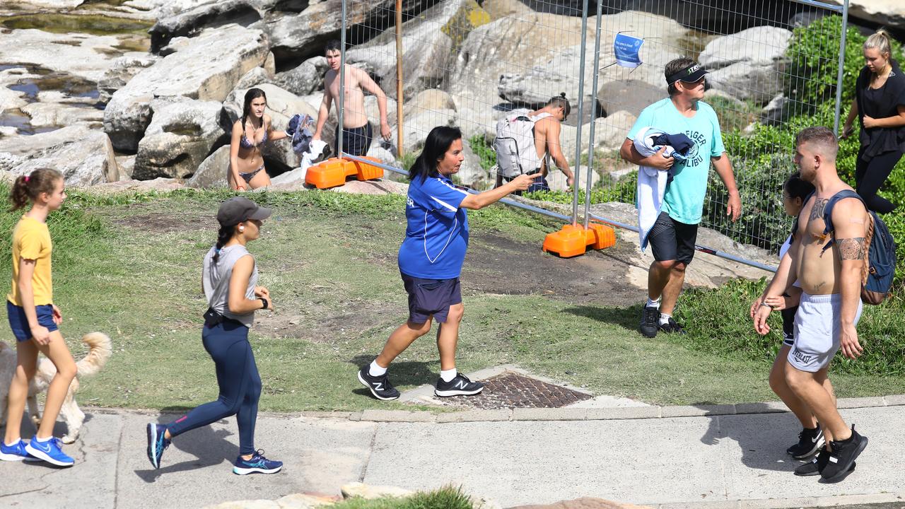 This council ranger was seen directing members of the public out of the area. Picture: Matrix