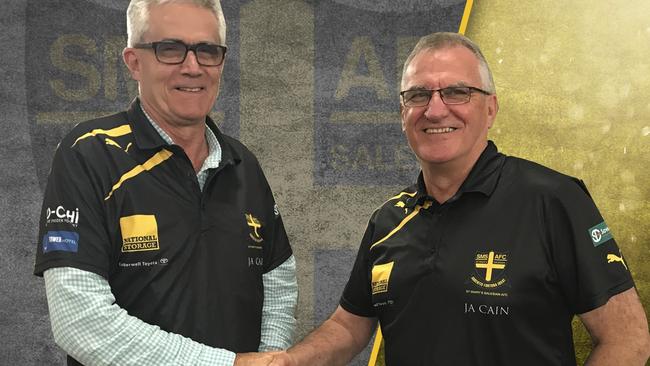 Changing of the guard, outgoing president Dave Malcolm hands the reins to Greg Baum