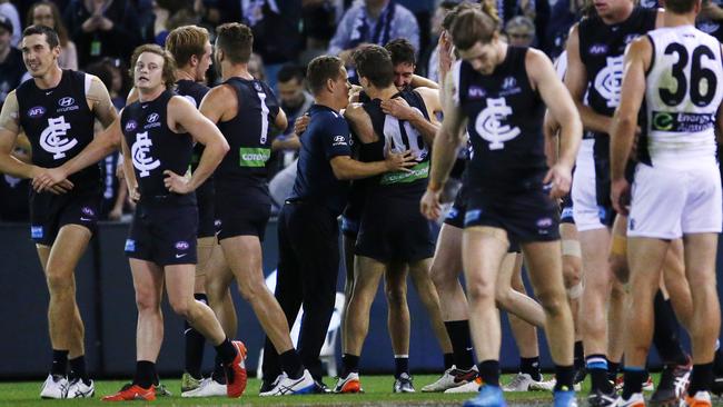 AFL: Round 8 Carlton V Port Adelaide at Etihad Stadium, Coach Brendon Bolton embraces Kade Simpson and Matthew Wright after the win. 15th May 2016. Picture: Colleen Petch.
