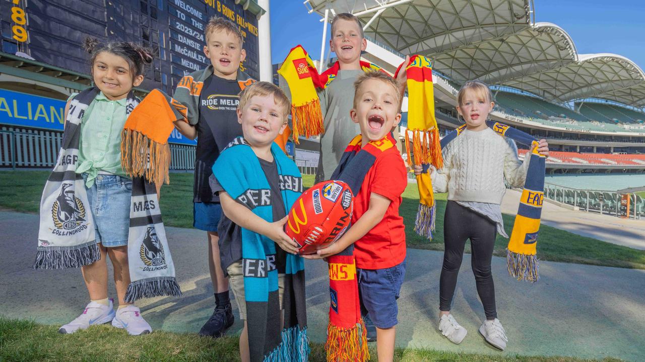 Young footy fans Sophie, Tommy, Jack, Alexa, and Lewis Eglinton and Jasper Welfare, front, can’t wait for Gather Round. Picture: Ben Clark