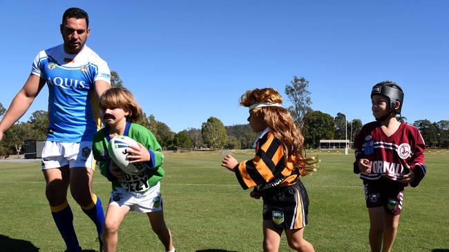 Billy Bakthier, Austin Highett, Jacob Worthing, Harry Caines and Marley Murphy from Currumbin Eagles Junior Rugby League Club with Titans captain Ryan James to launch Fox LeagueÕs Retro Round at Parkwood. Photo: Steve Holland