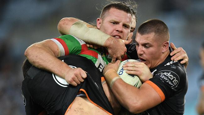 Nathan Brown of the Rabbitohs is tackled by Mitchell Moses, (left), and Kyle Lovett of the Tigers during the round 14 NRL match between the Wests Tigers and the South Sydney Rabbitohs at ANZ Stadium in Sydney, Friday, June 10, 2016. (AAP Image/Dan Himbrechts) NO ARCHIVING, EDITORIAL USE ONLY