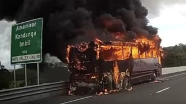 A woman was taken to Gympie Hospital after the coach she and 22 other golfers were travelling on burst into flames on the Bruce Highway near Kybong on Tuesday morning.