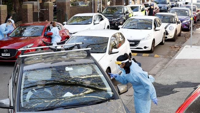 Staff administer COVID-19 tests to queues at the COVID-19 drive through testing clinic in Balmain in Sydney on Friday. Picture: Nikki Short