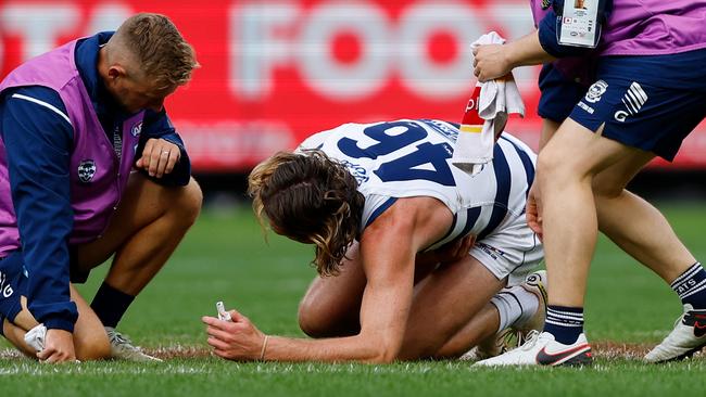 Trainers rush to Mark Blicavs after being injured by an errant knee. Picture: Dylan Burns/AFL Photos via Getty Images