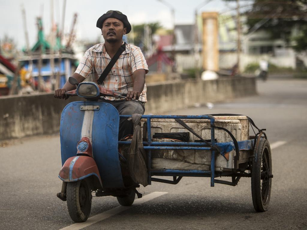 A local rides along the foreshore in Banda Aceh, Indonesia. Picture by Matt Turner.