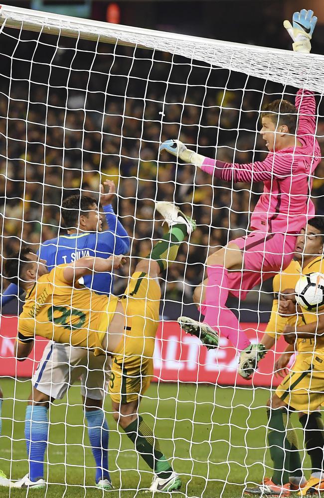 Brazil's Thiago Silva heads the ball past Mitchell Langerak and Bailey Wright.