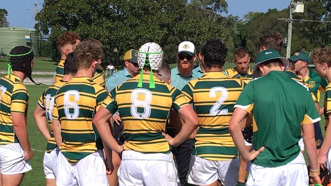 St Patrick's coach Josh Neilsen addresses his players at halftime against St Laurence's College.