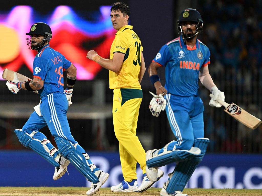 India's Virat Kohli (L) and KL Rahul run between the wickets as Australia's captain Pat Cummins looks on. Picture: AFP