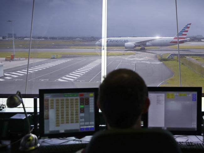 WEEKEND TELEGRAPHS - 14/2/23  MUST CHECK WITH PIC EDITOR JEFF DARMANIN BEFORE PUBLISHING  -Airservices Aviation Rescue Fire Fighters pictured at Mascot this morning. A firefighter spends part of his shift in the tower watching planes land and take off. Picture: Sam Ruttyn