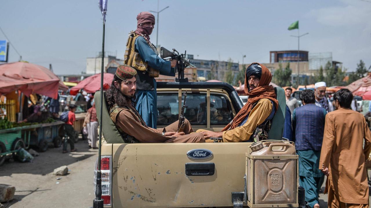 Taliban fighters on a pick-up truck move around the market area. Picture: Hoshang Hashimi