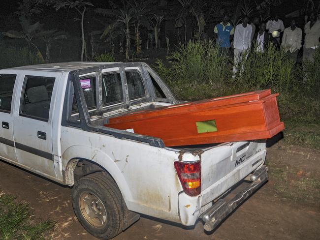 Villagers look on from a distance as the coffin arrives for the burial of Agnes Mbambu, the 50-year-old grandmother of the 5-year-old boy who became Ebola's first cross-border victim, who died of ebola, in the village of Karambi, near the border with Congo, in western Uganda Thursday, June 13, 2019. Picture: Ronald Kabuubi