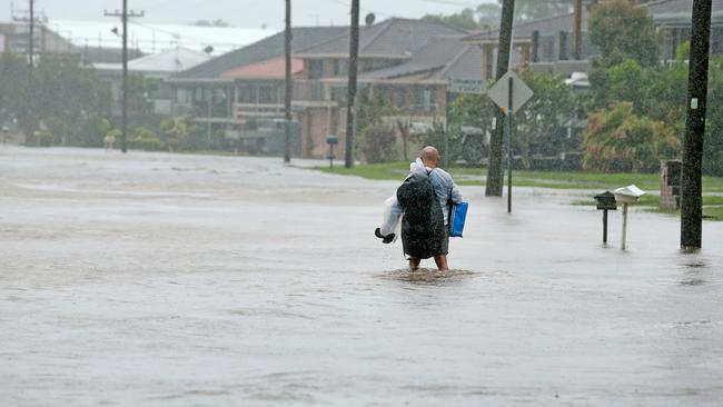 A resident tries to make his way back home on Settlement Point rd, Port Macquarie. Picture: Nathan Edwards