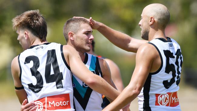 Dylan Williams, left, celebrates a goal with Boyd Woodcock, centre, and Cam Sutcliffe Picture: David Mariuz/AAP