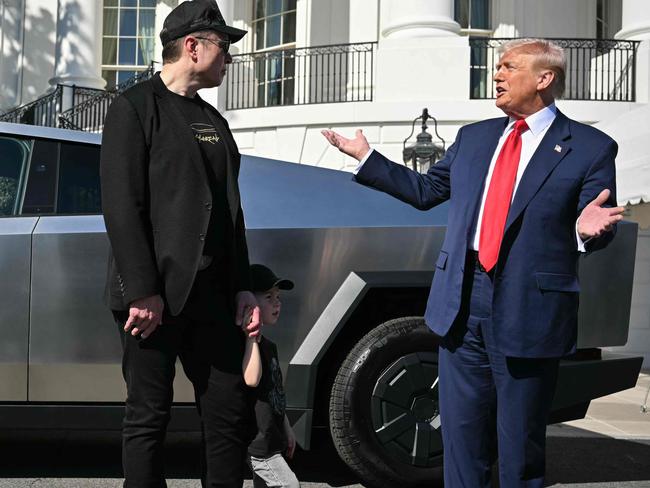 (FILES) US President Donald Trump and Tesla CEO Elon Musk speak to the press as they stand next to a Tesla Cybertruck on the South Portico of the White House on March 11, 2025 in Washington, DC. Tesla reported a 13 percent drop in first quarter auto sales April 2, 2025, amid lower production during factory upgrades and blowback over CEO Elon Musk's work for President Donald Trump's administration. Musk's electric vehicle company delivered 336,681 autos in the quarter ending March 31, missing analyst expectations, as it pointed to the 
