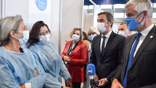 French Health Minister Olivier Veran at the opening day of a mass COVID-19 vaccination centre in eastern France. plans for similar centres could be on the cards in Australia. Pictures: Philippe Desmazes/AFP