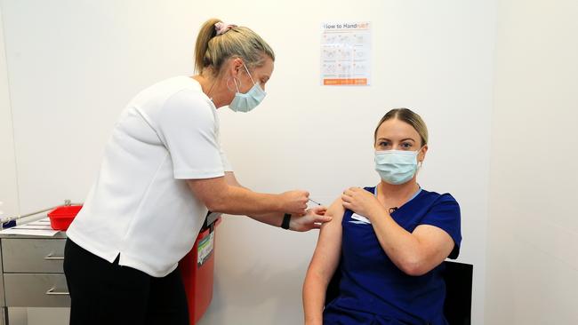 Grace Gibney receives a jab from Sonja Elia on Monday. Picture: Mark Stewart