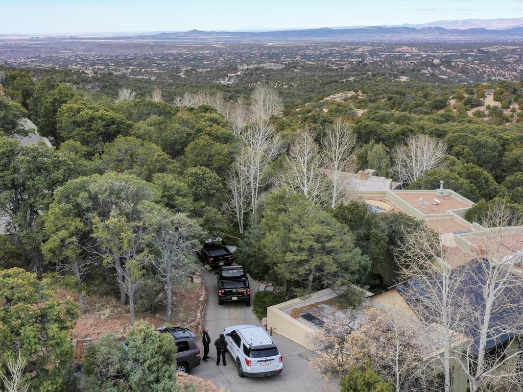 Santa Fe County deputies remain outside the house belonging to actor Gene Hackman and his wife Betsy Arakawa were earlier found dead. Picture: AP Photo/Roberto E. Rosales