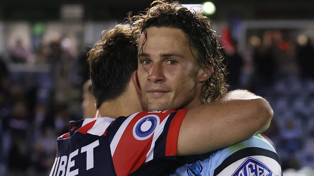 Nicholas Hynes of the Sharks and Brandon Smith of the Roosters embrace. (Photo by Mark Metcalfe/Getty Images)