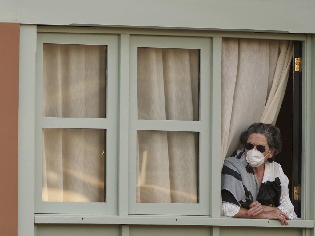 A quarantined woman looks out the window of her room. Picture: AP