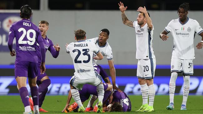 Players rushed to Edoardo Bove. Photo by Gabriele Maltinti/Getty Images.