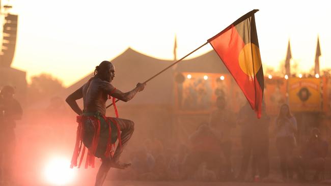 18/8/2018: Aboriginal traditional dancer with the aboriginal flag, perform traditional dance in the  at the Gulf Country Frontier Music Festival, in Gregory Downs, about 3 hrs north of Mount Isa, QLD.   Lyndon Mechielsen/The Australian