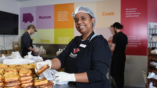 Elizabeth Desire (centre), James Walker and Chris Seeley working in the FareShare kitchen packing quiches. Picture: Josie Hayden