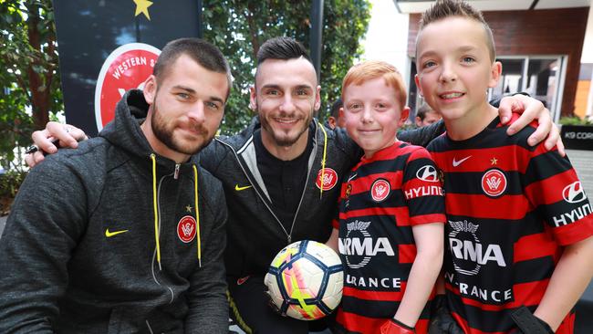 L-R Western Sydney Wanderers players Brendan Hamill and Vedran Janjetovic sign a ball for 9 year old Callum Garbers and his brother 11 year old Harrison Garber at The Coffee Emporium, Stanhope Village. Pictures: Angelo Velardo