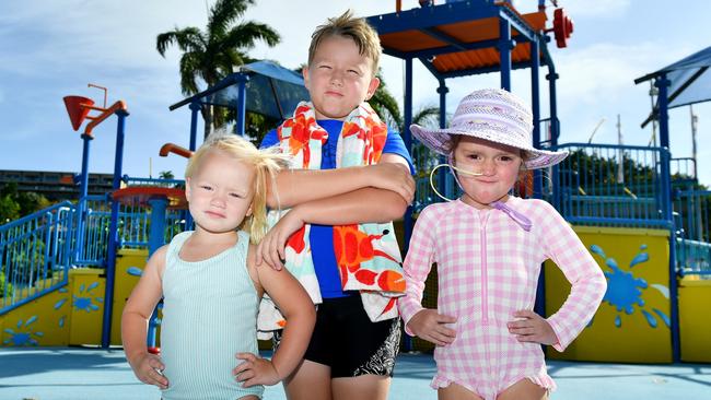 Harper 3, Chase 7 and Aivah Evans 4, visiting from Cairns with her family, is unhappy to miss out on the Strand Waterpark due to water restrictions. Picture: Alix Sweeney