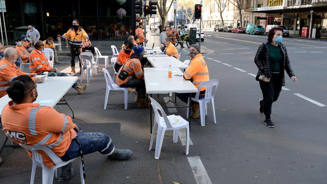 The workers set up tables and chairs in the middle of the street. Picture: Andrew Henshaw