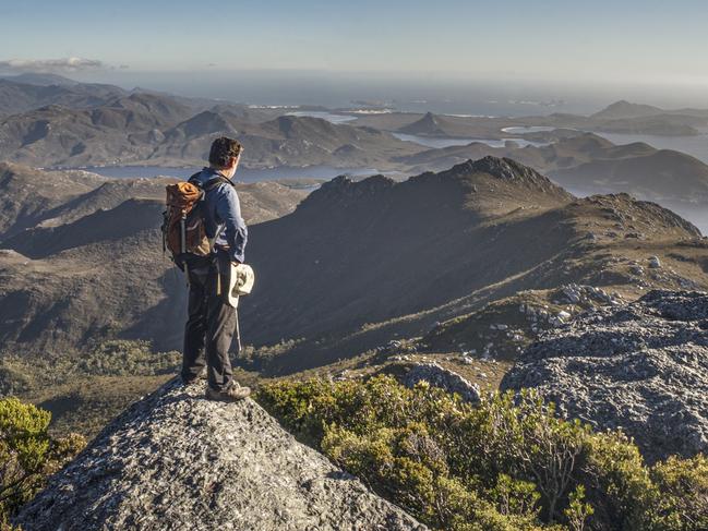 Peter Marmion on the summit of Mount Berry. The image features in Peter's new book Hidden Worlds. For TasWeekend. Picture: Jimmy Emms/Hobart Yachts