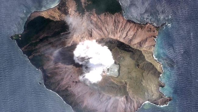 A satellite image of White Island, which continues to spew smoke and steam