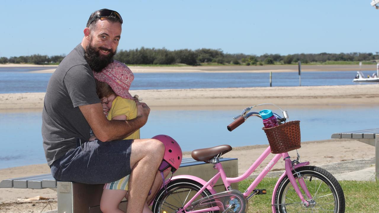 Zane halligan from labrador consoles daughter Zarli 4 after a bicycle incident.. Picture Glenn Hampson