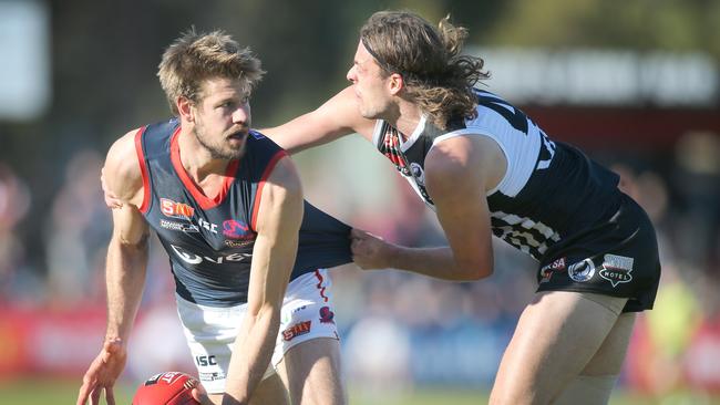 Norwood's Brady Dawe under pressure from Port's Jarrod Lienert.