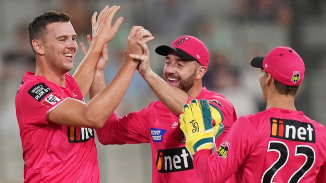 Josh Hazlewood celebrates a wicket with Sixers teammates James Vince and Josh Philippe.