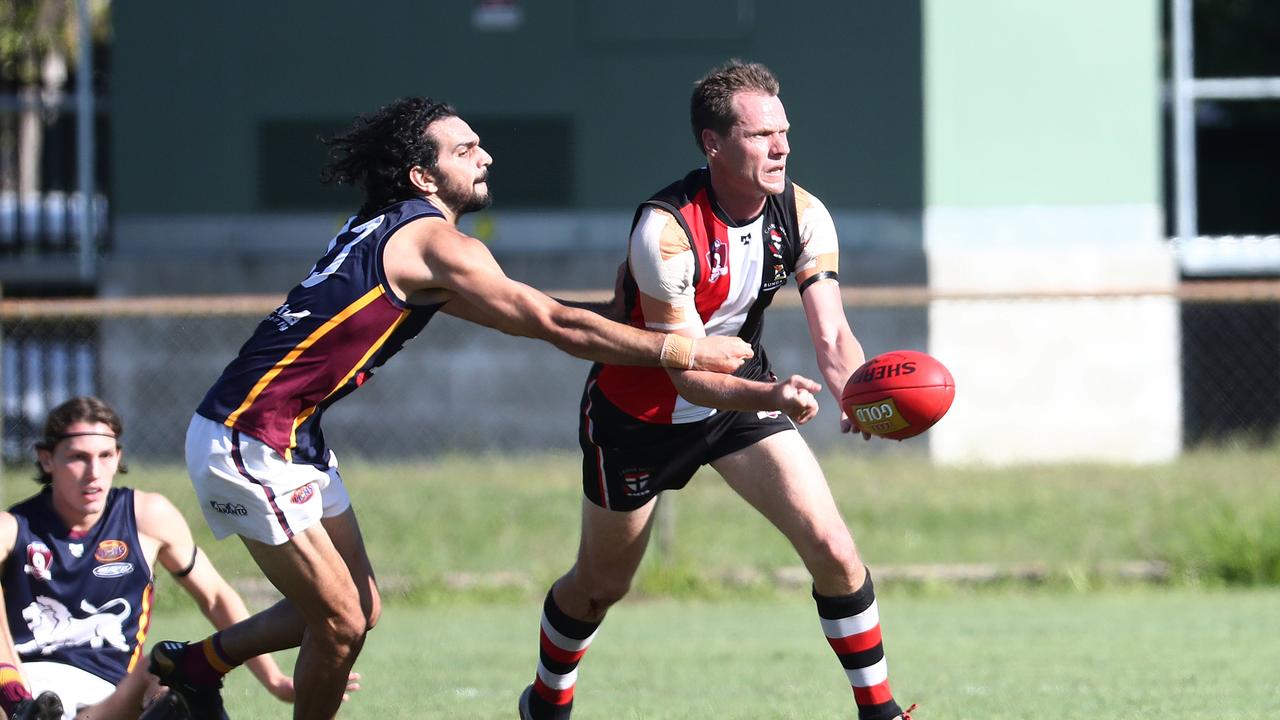 Saints' Wes Glass keeps the ball away from Lion's Jake Long in the AFL Cairns seniors match between the Cairns Saints and the Cairns City Lions, held at Griffiths Park. Picture: Brendan Radke