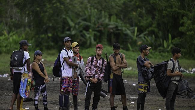 Migrants, mostly Venezuelans, cross a river during their journey through the Darien Gap from Colombia into Panama in October 2022, part of a surge of migration toward the U.S. Picture: Luis Acosta/AFP