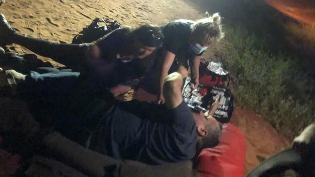 Boyd Sampson, 54, receives first aid following a 'traumatising' camel attack in Central Australia. Picture: Supplied.