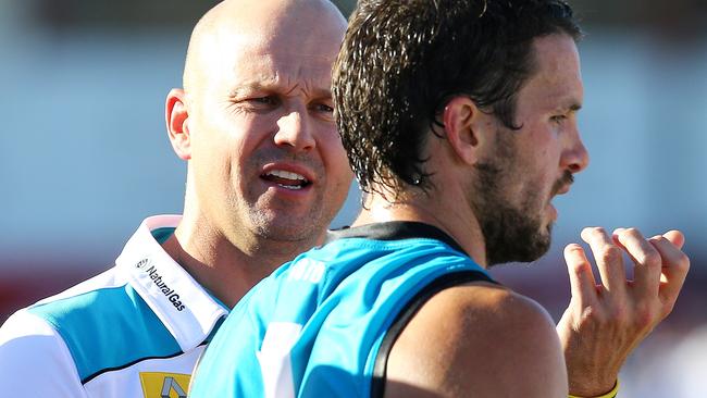 Matthew Nicks speaks to captain Travis Boak as he steps in as acting senior coach for the 2015 NAB Challenge. Picture: Sarah Reed