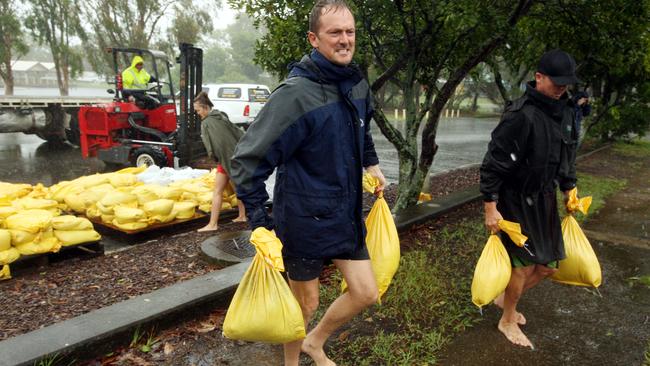 Locals collect sandbags, for use if needed later in the day, in Sandgate.